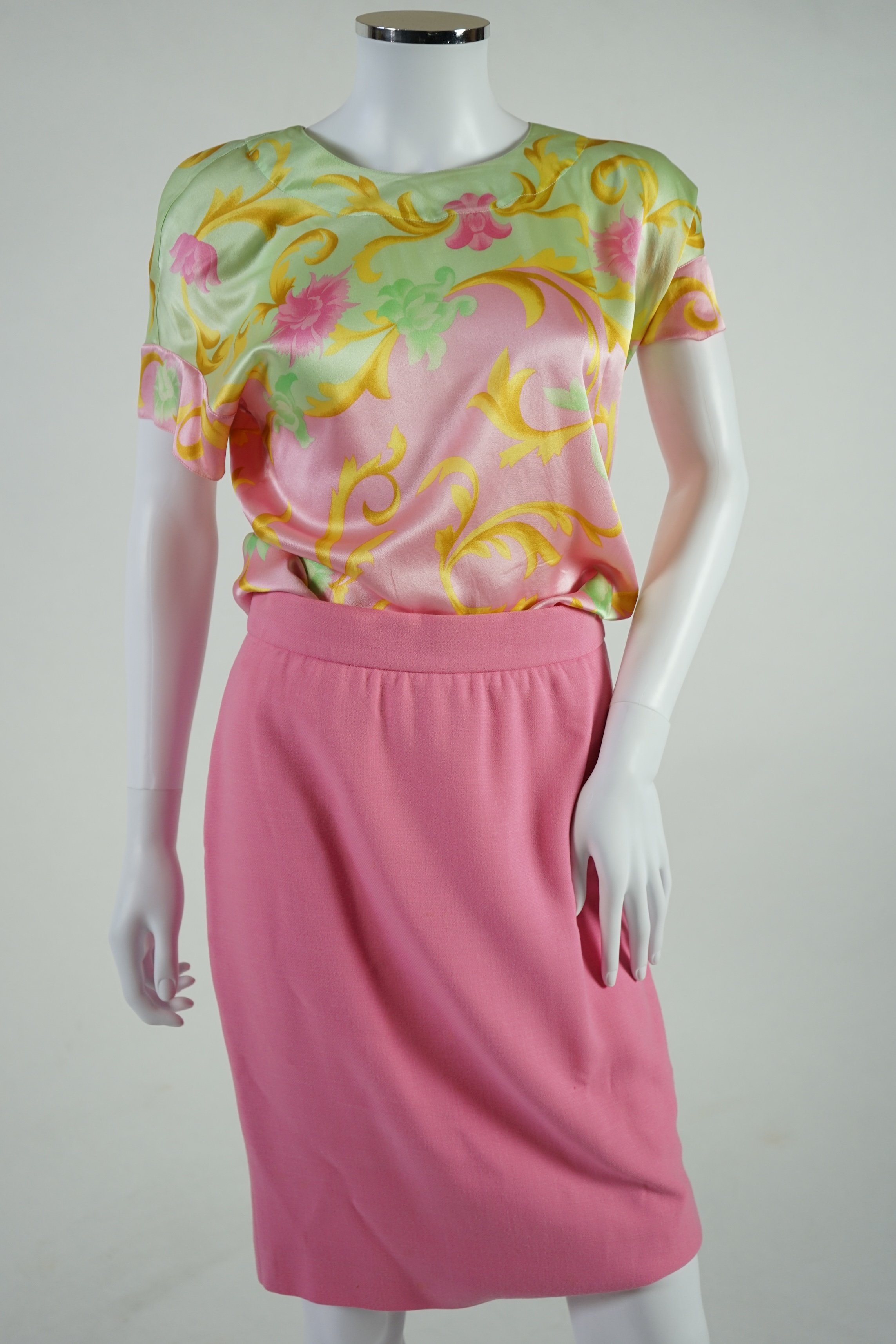A pink Escada suit with a silk blouse top. Proceeds to Happy Paws Puppy Rescue